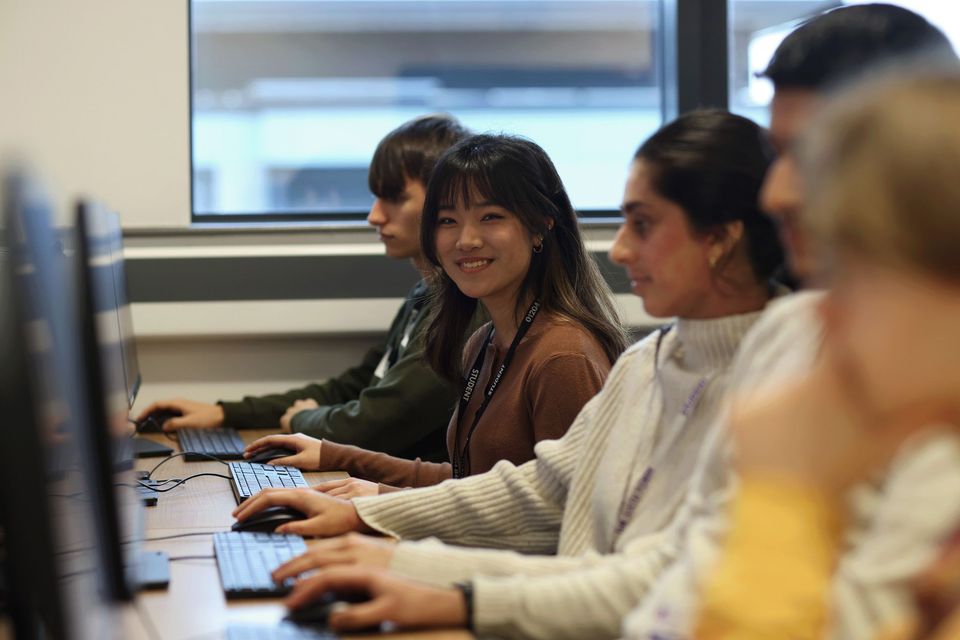 Image of three students at computers