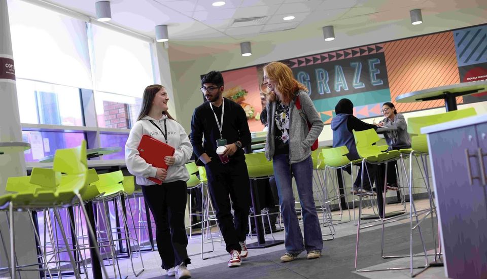 image of students walking through bistro