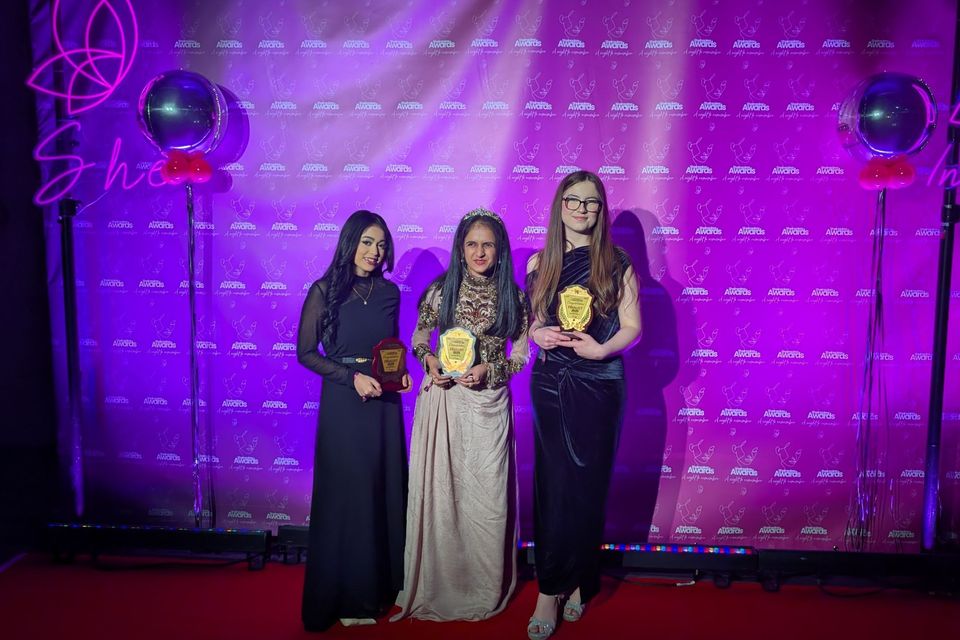 Image of three students at awards ceremony