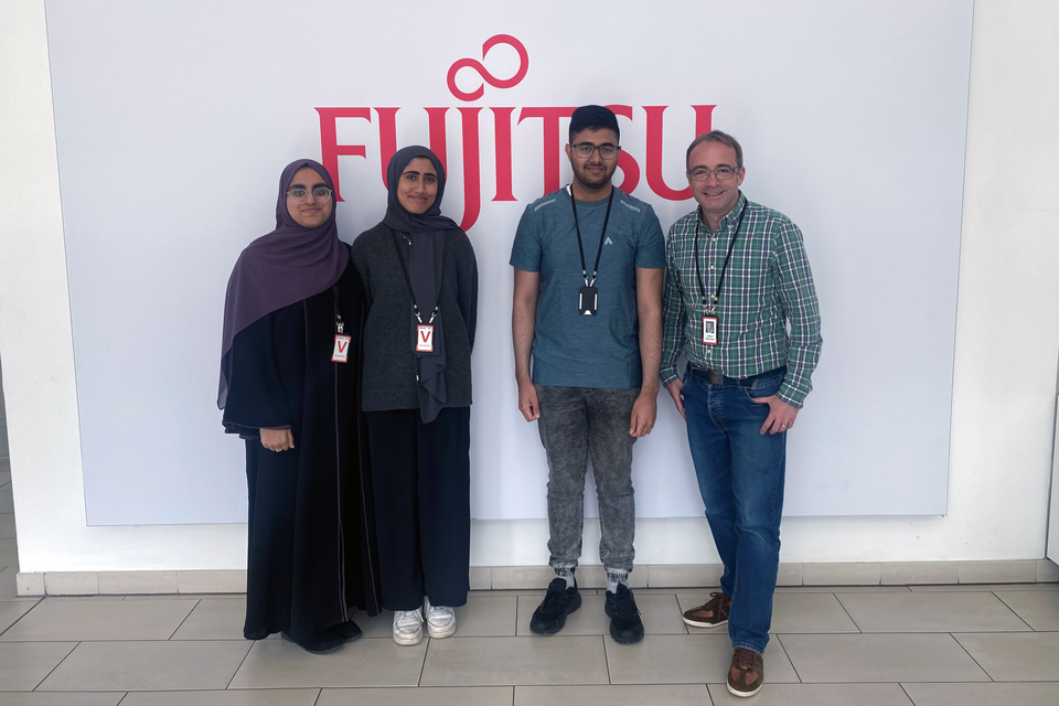 Students Aliyah Mogra, Kulsum Sufi & Daniyal Alvi with Fujitsu’s James Sharman